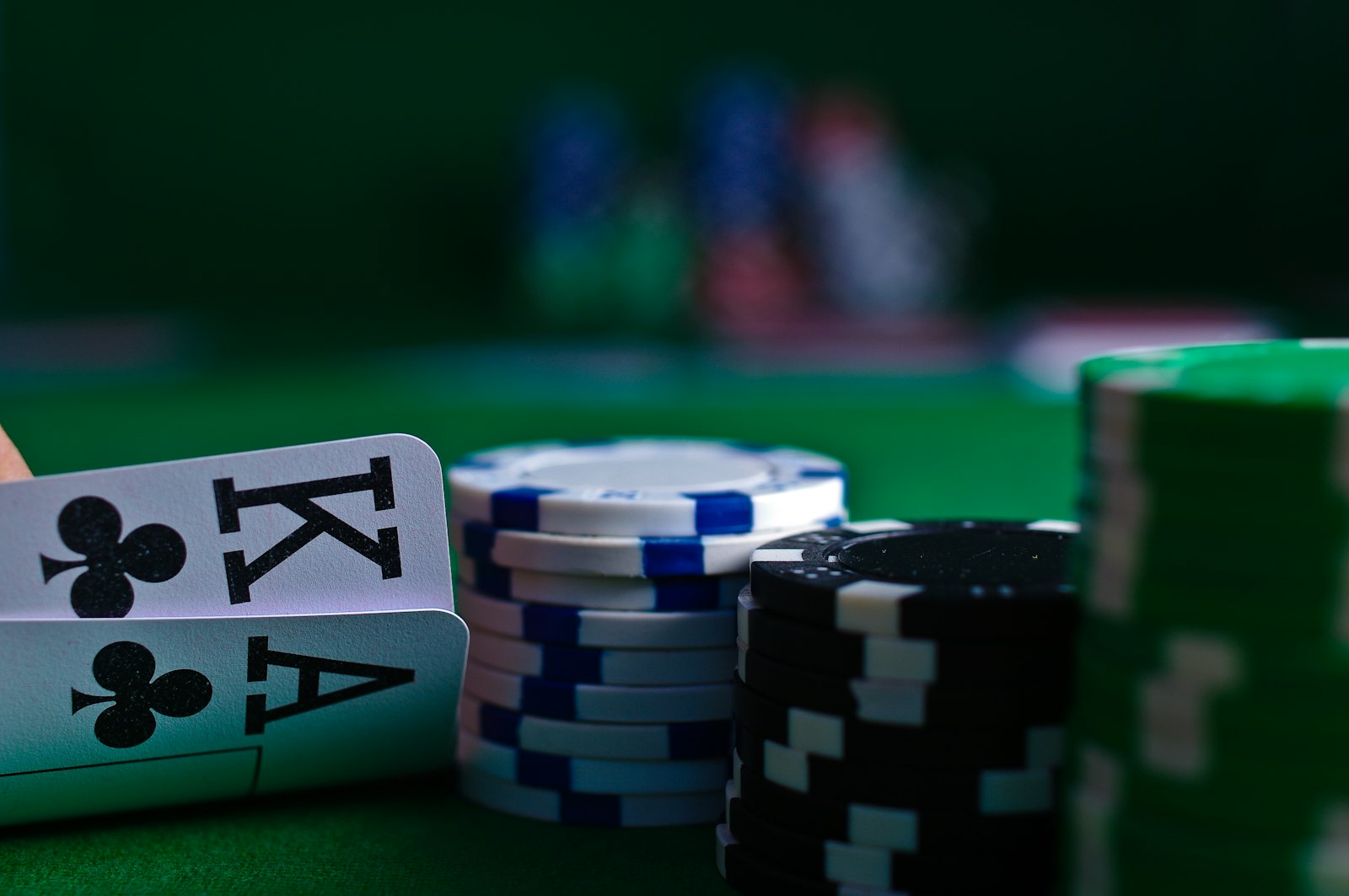 Playing cards and casino chips on a green felt table